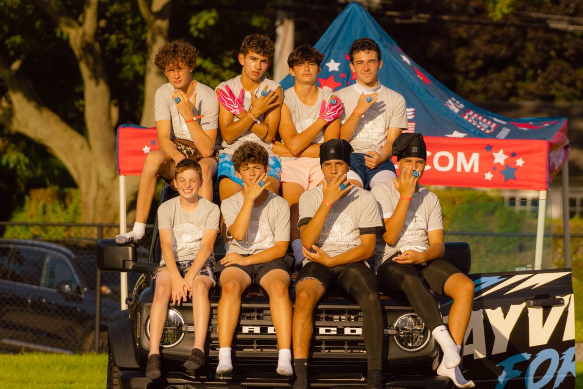 A team posing on the sponsor truck